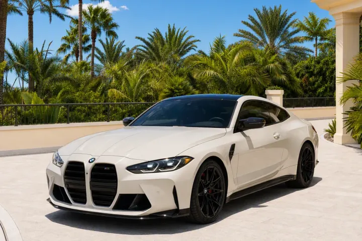 White BMW M4 Competition, front three-quarter view